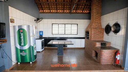 a kitchen with a refrigerator in the middle of a room at Casa com Piscina e Lazer Completo em Barra Bonita in Igarassú