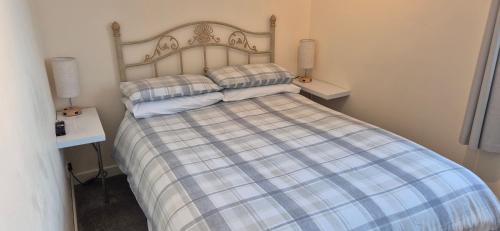 a bedroom with a bed with two pillows on it at Flat 21 - 1st floor - Westview Terrace, Stornoway in Stornoway