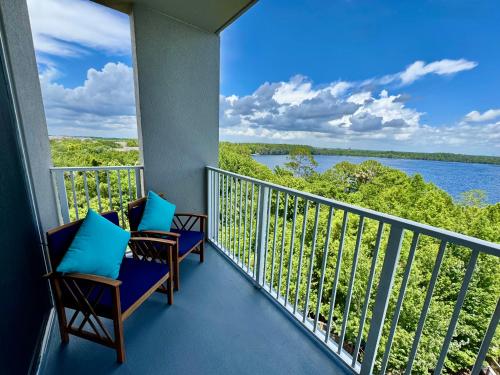 a balcony with chairs and a view of a lake at Balcony Lake Views - Pool, Gym, WiFi & Parking in Orlando