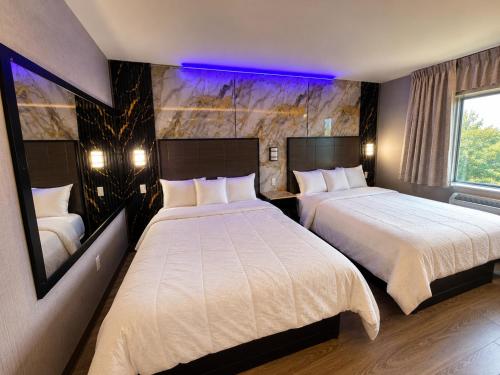 a hotel room with two beds and a window at Imperial Hotel Brooklyn New in Brooklyn