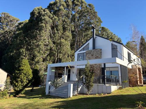 a house on a hill with trees at Nest On Thula in Dullstroom
