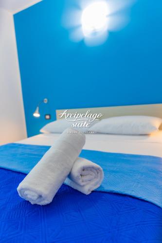a towel laying on a bed in a room at Arcipelago Suite in Belvedere Marittimo