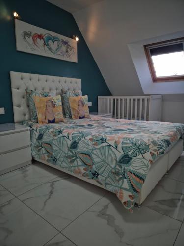 a bedroom with a large bed with a floral bedspread at BELLE MAISON A Ménars in Menars