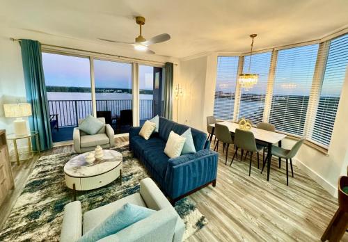 a living room with a blue couch and a table at Balcony Lake Views - Pool, Gym, WiFi & Parking in Orlando