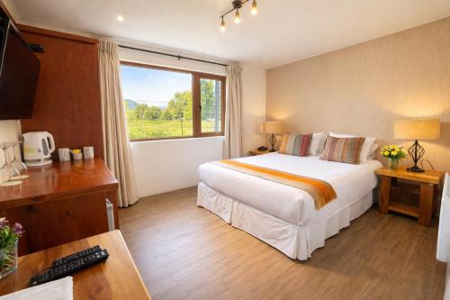 a hotel room with a bed and a window at Martina de Goñi in Pucón