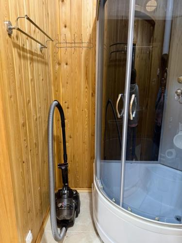 a shower in a bathroom with a vacuum at Kausar cottage in Cholpon-Ata