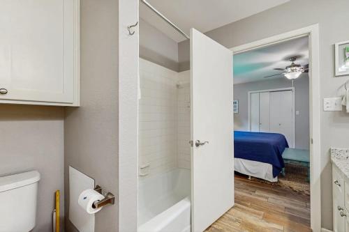 a bathroom with a tub and a bedroom with a bed at Dog-Friendly Lakefront Home with Private Sundeck in Kingsland