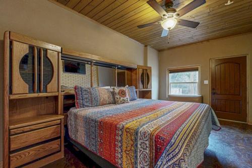 a bedroom with a bed and a ceiling fan at Renovated Waterfront Home with WiFi, Lake Views, Dock & Boat Lift - Dogs OK in Buchanan Dam