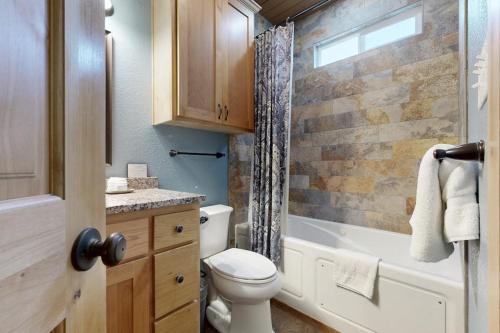 a bathroom with a toilet and a tub and a sink at Renovated Waterfront Home with WiFi, Lake Views, Dock & Boat Lift - Dogs OK in Buchanan Dam