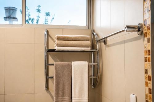 a towel rack in a bathroom with towels at Comfortable with Private Garage and Excellent Location Rb in Riobamba