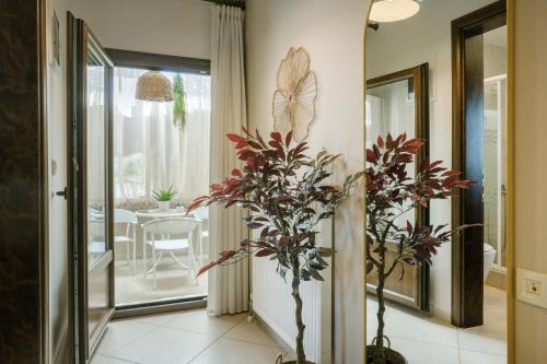 a hallway with a plant and a dining room at IFESTOS APARTMENTS in Ierissos