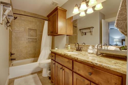 a bathroom with a sink and a tub and a toilet at Lakefront Home with WiFi, Entertainment, Dock & Lake Views - Dogs OK in Buchanan Dam