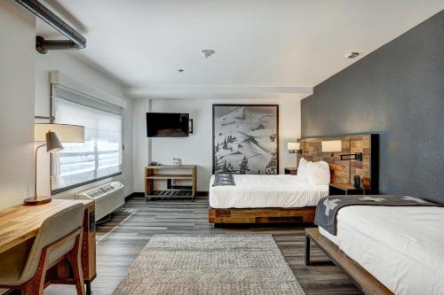 a bedroom with two beds and a large window at Gravity Haus Breckenridge in Breckenridge