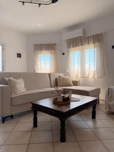 a living room with a couch and a coffee table at The Family Villa in Tragasiá