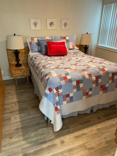a bedroom with a bed with a red pillow on it at #13 Condo near large pool-Gorge shuttle-book separately in Quincy