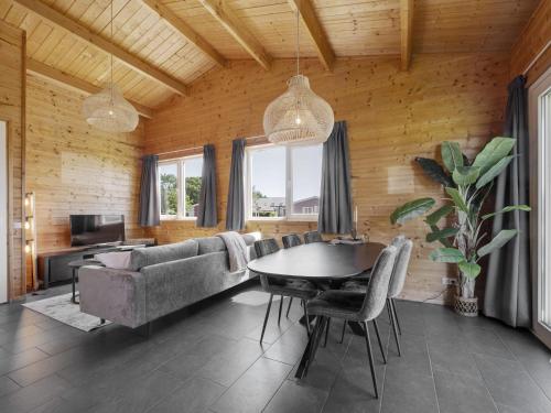 a living room with a table and a couch at Country Holiday home with shared pool in Someren-Heide
