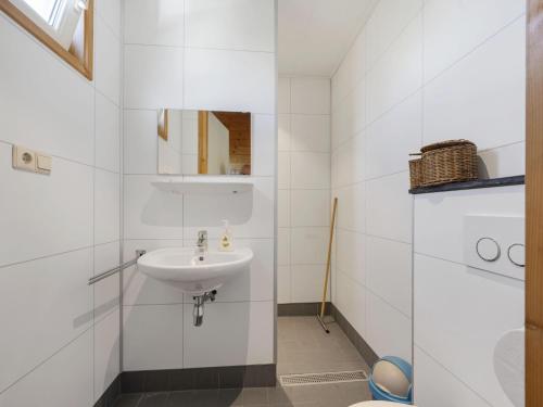 a white bathroom with a sink and a toilet at Country Holiday home with shared pool in Someren-Heide