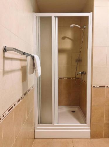 a shower with a glass door in a bathroom at Annabella in Riga