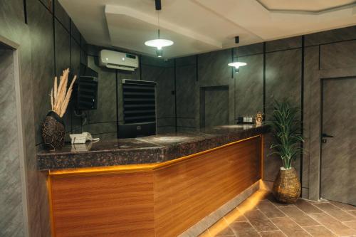 a bathroom with a counter with a sink and a mirror at Muster Point Hotel & Suites in Port Harcourt