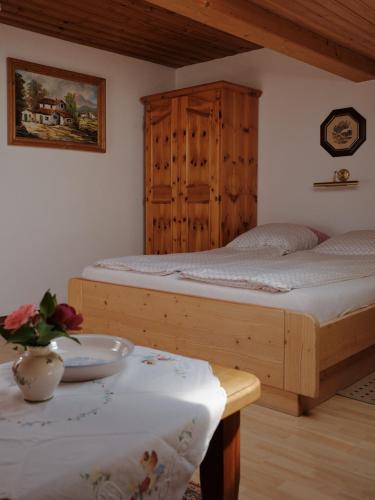 a bedroom with two beds and a table with a bowl at Gschwingerhof in Riedering