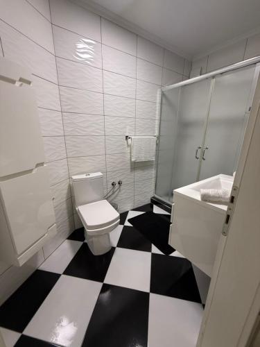 a bathroom with a black and white checkered floor at Serenity Apartment in Struga