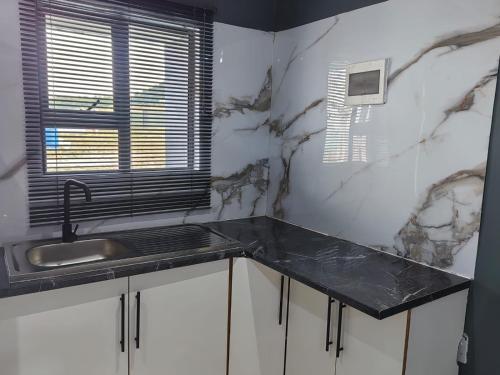 a kitchen with a sink and a counter top at Qten Camp in Pietermaritzburg