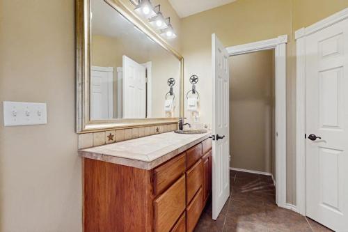 a bathroom with a sink and a large mirror at Waterfront Home with Kayak, View, Fire Pit & WiFi - Dog-Friendly in Buchanan Dam
