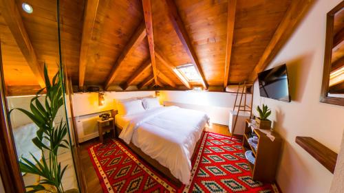 a bedroom with a bed and a tv in a room at Sokak Boutique Hotel in Berat