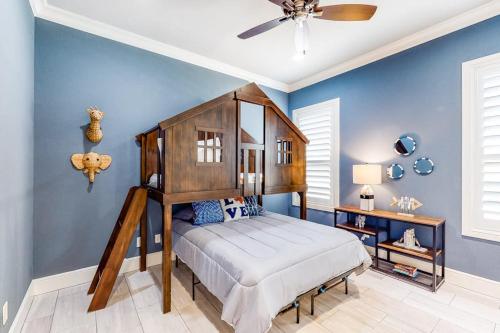 a bedroom with a canopy bed and blue walls at Bright & Spacious Family Home with Firepit, Lake Views, Furnished Deck, Free WiFi in Lago Vista