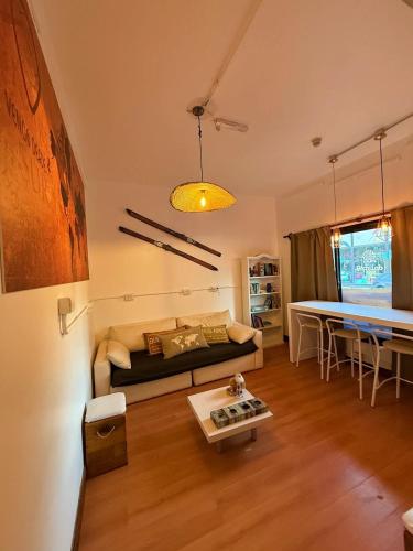 a living room with a couch and a table at Torre al Sur in Ushuaia