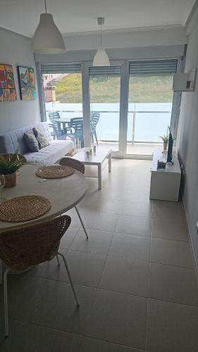 a living room with a couch and a table at Apartamentos en playa Canido in Malpica