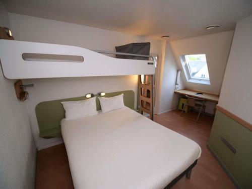 a bedroom with a bunk bed and a desk at ibis budget Blois Centre in Blois