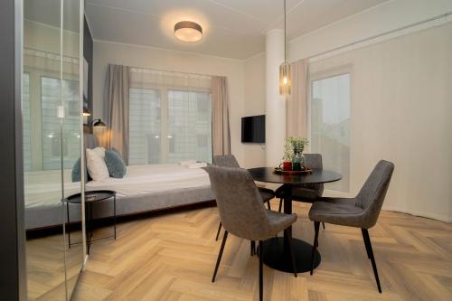 a bedroom with a bed and a table and chairs at Luise LuXe Suites in Tallinn