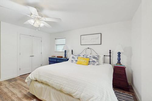 a bedroom with a bed and a ceiling fan at Lakefront Home on Water with Great Views, Boat Dock, Al Fresco Dining, and WiFi in Kingsland
