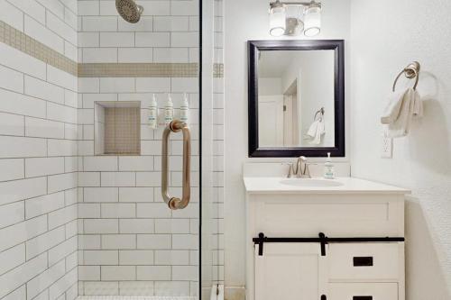 a bathroom with a shower and a sink and a mirror at Lakefront Home on Water with Great Views, Boat Dock, Al Fresco Dining, and WiFi in Kingsland