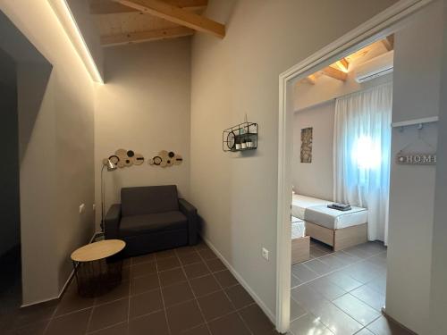 a living room with a couch and a bed at S&S Home in Petalidi