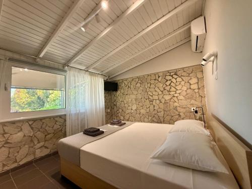 a bedroom with a large white bed with a window at S&S Home in Petalidi
