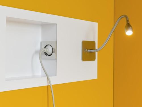 a light with a cord plugged into a white switch at ibis budget Tambore in Barueri