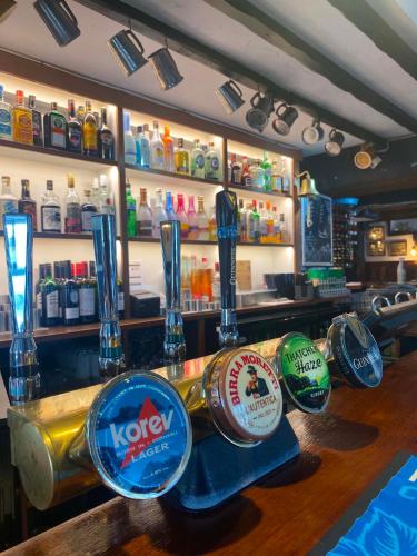 a bar with many bottles of alcohol on a counter at The Top House Inn in Lizard
