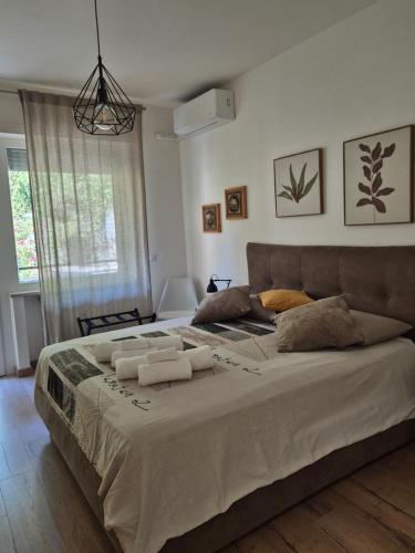 a bedroom with a large bed with towels on it at Casa Sabina in Sanremo
