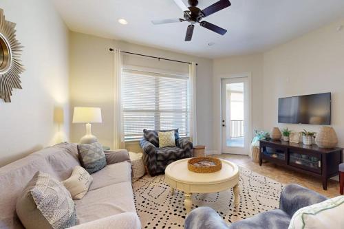a living room with a couch and a tv at Hill Country Corner Condo at The Waters - Central AC, Lake Views & Pool in Horseshoe Bay