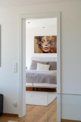 a bedroom with a bed and a painting at Eifelvilla Weber in Arenrath