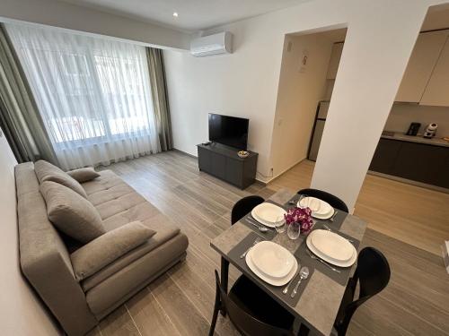 a living room with a couch and a table with chairs at Makala Accommodation in Split