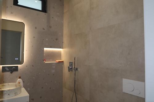 a bathroom with a sink and a mirror at Panorama Hill Villa Tirana - Private Pool & Views in Tirana