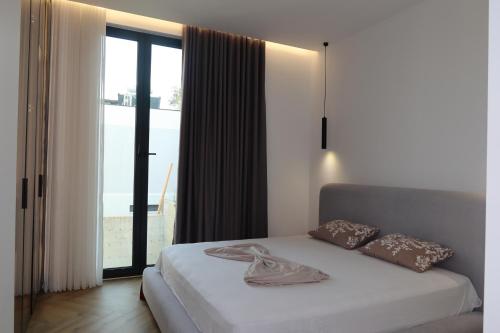 a bedroom with a bed and a large window at Panorama Hill Villa Tirana - Private Pool & Views in Tirana