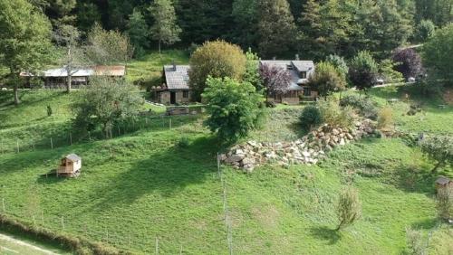 an aerial view of a field with a house and trees at La Bernadole - Chambres d'Hôtes in Aleu