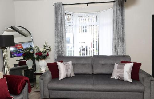 a living room with a couch and a window at Pasture Side House in Clayton