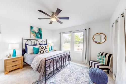 a bedroom with a bed and a ceiling fan at Peaceful Mid-Century Escape with Screened Porch & Lake Access in Lago Vista