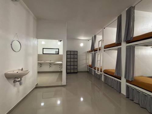 a bathroom with two bunk beds and a sink at Jimbaran Hostel Bali in Jimbaran
