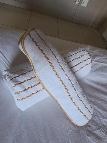 two white towels on top of a bed at Mafjoint6 in eMalahleni